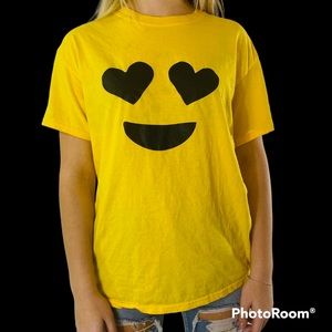 A bright yellow T-shirt with hearts as a smiley face.
